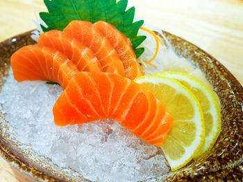 Close-up of orange slice in plate on table