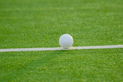 Close-up of golf ball on field