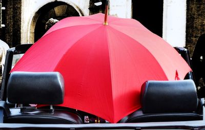 Red umbrella in convertible car