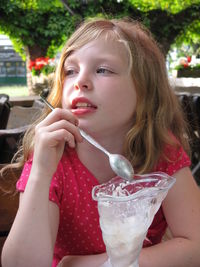 Close-up of young woman drinking juice