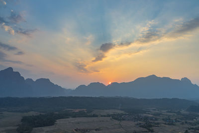 Scenic view of silhouette mountains against sky during sunset