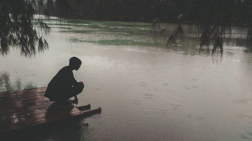 Man fishing in lake