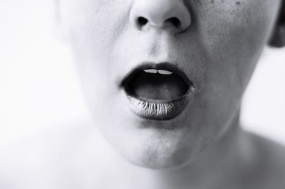 Close-up of woman wearing lipstick with mouth open