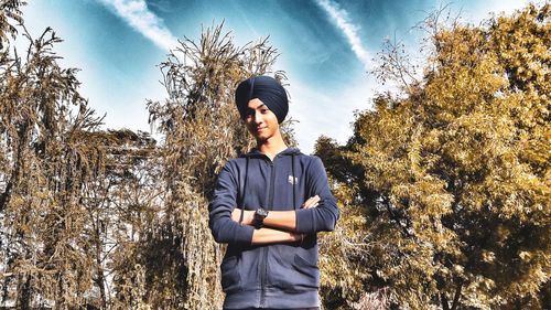 Portrait of young man standing against plants