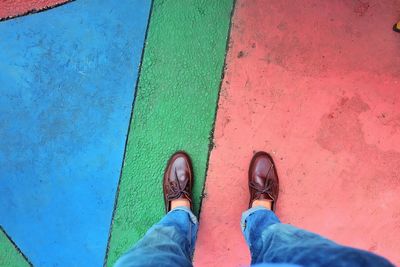 Low section of man standing on footpath
