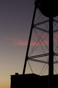 Low angle view of silhouette bridge against sky at sunset