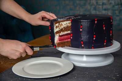 Midsection of person holding ice cream in plate