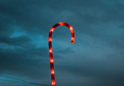 Low angle view of illuminated light against sky at night