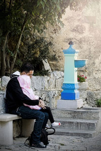 Midsection of man sitting outdoors