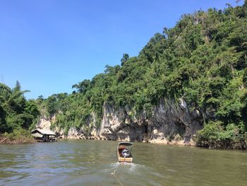 Boat in river against sky