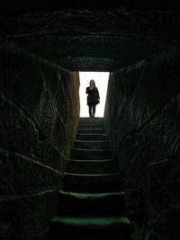 Low angle view of woman standing on steps at castillo de la mota