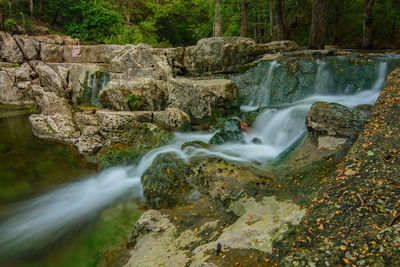 Stream flowing amidst rocks at balcones district park