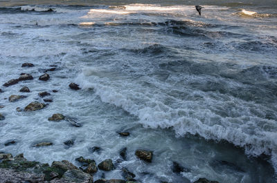 Waves splashing on rocks at beach