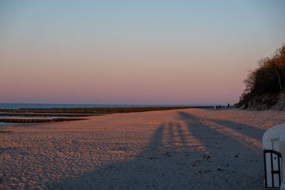 Scenic view of road against clear sky during sunset