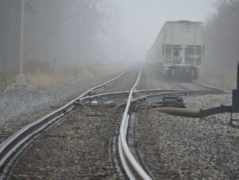 Railroad tracks amidst trees against sky