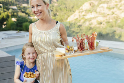 Mother with daughter at swimming-pool