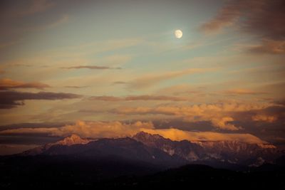 Scenic view of mountains against cloudy sky