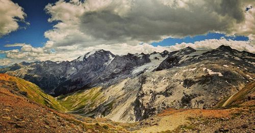 Scenic view of mountains against cloudy sky