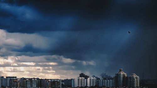 Cityscape against storm clouds