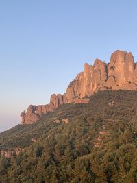 Rock formations on landscape against clear sky