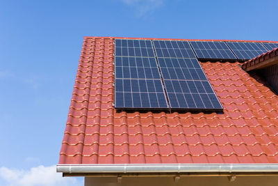Low angle view of solar panel on rooftop against sky