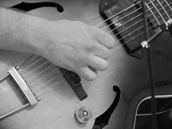 Close-up of man playing guitar