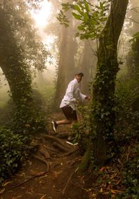 Full length of young man in forest