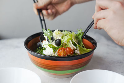 Midsection of person having food on table