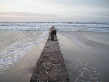 Shadow of person on beach against sky