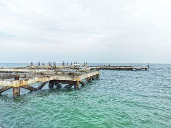 Pier over sea against sky