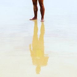 Low section of woman standing on tiled floor