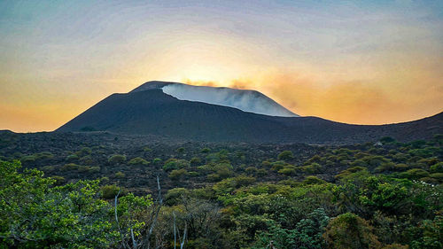 Scenic view of mountains against sky during sunset