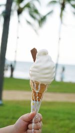 Close-up of hand holding ice cream cone