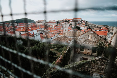 High angle view of buildings in town against sky