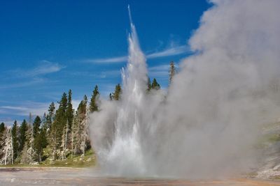 Panoramic view of waterfall against sky