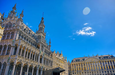 Low angle view of buildings against blue sky