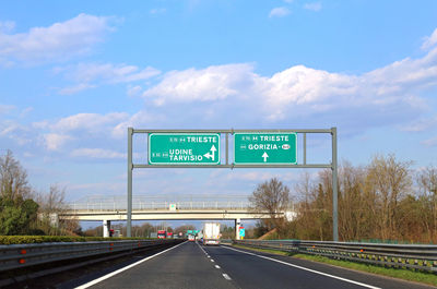 Road sign against sky