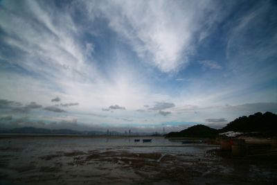 Scenic view of sea against cloudy sky