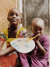 Portrait of smiling boy holding girl