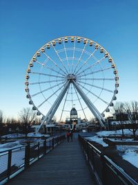 Ferris wheel against sky during winter