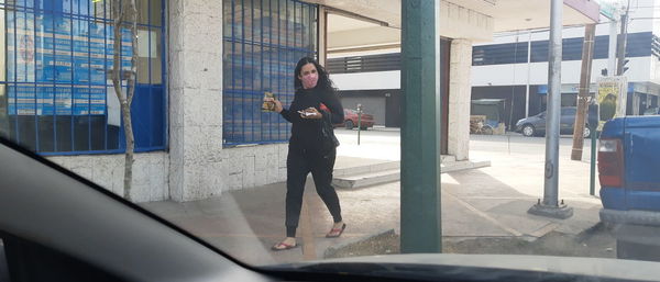 Full length of man holding glass window