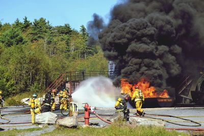 Firefighters extinguishing burning object