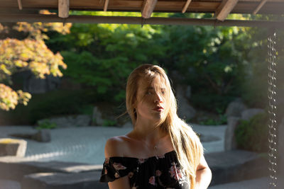 Portrait of woman against blurred background