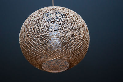 Hanging from the ceiling is a decorative lampshade made of twine