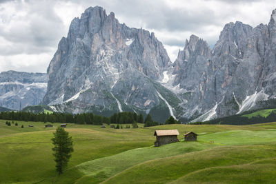 Scenic view of field and mountains against sky