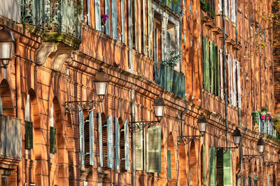 Low-sun shadows of trees on the houses along the garonne in toulouse, france.