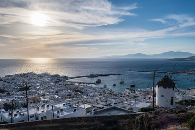 High angle view of townscape by sea against sky