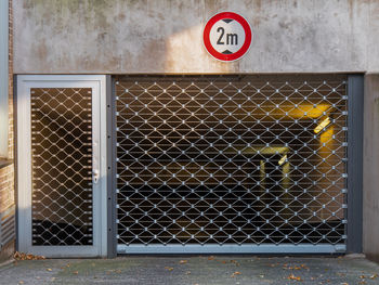 Road sign against fence