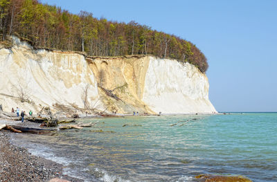 Scenic view of sea by chalk cliff