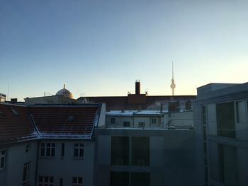 Low angle view of buildings against clear blue sky